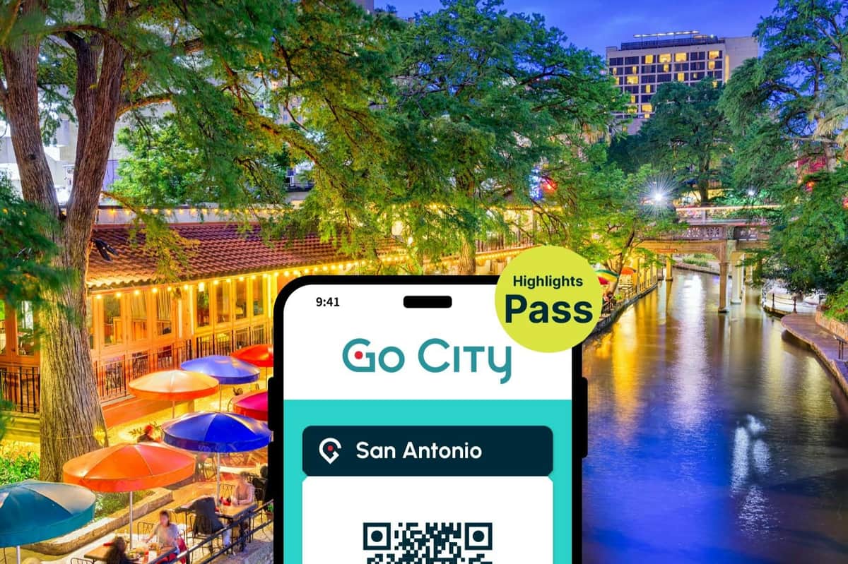 A digital pass for San Antonio from Go City displayed on a smartphone screen against a vibrant riverside evening scene.