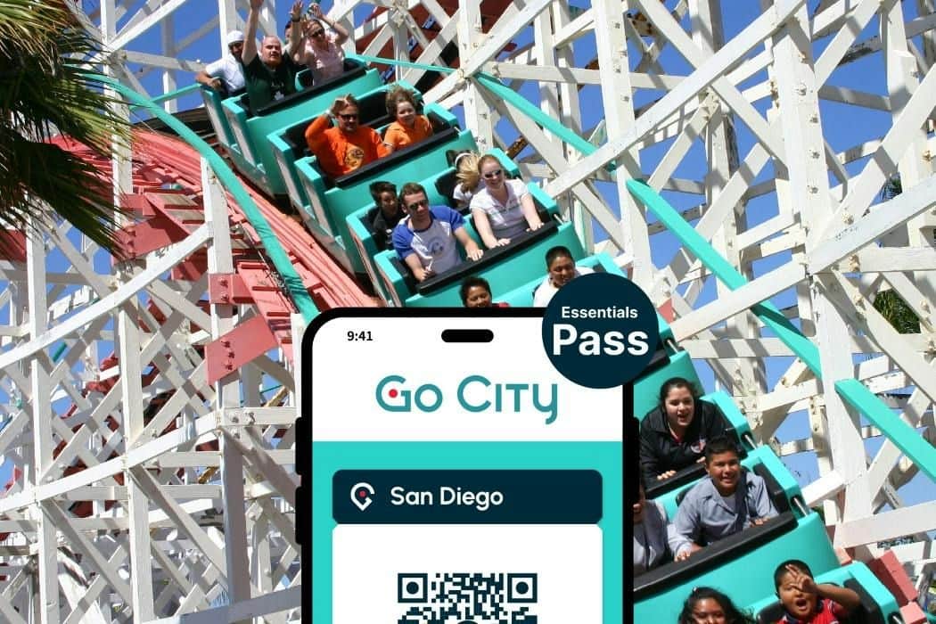 Go City San Diego Essentials Pass: Choose 3 Attractions (San Diego) People riding a rollercoaster with a phone screen in the foreground displaying a "Go City San Diego Essentials Pass."