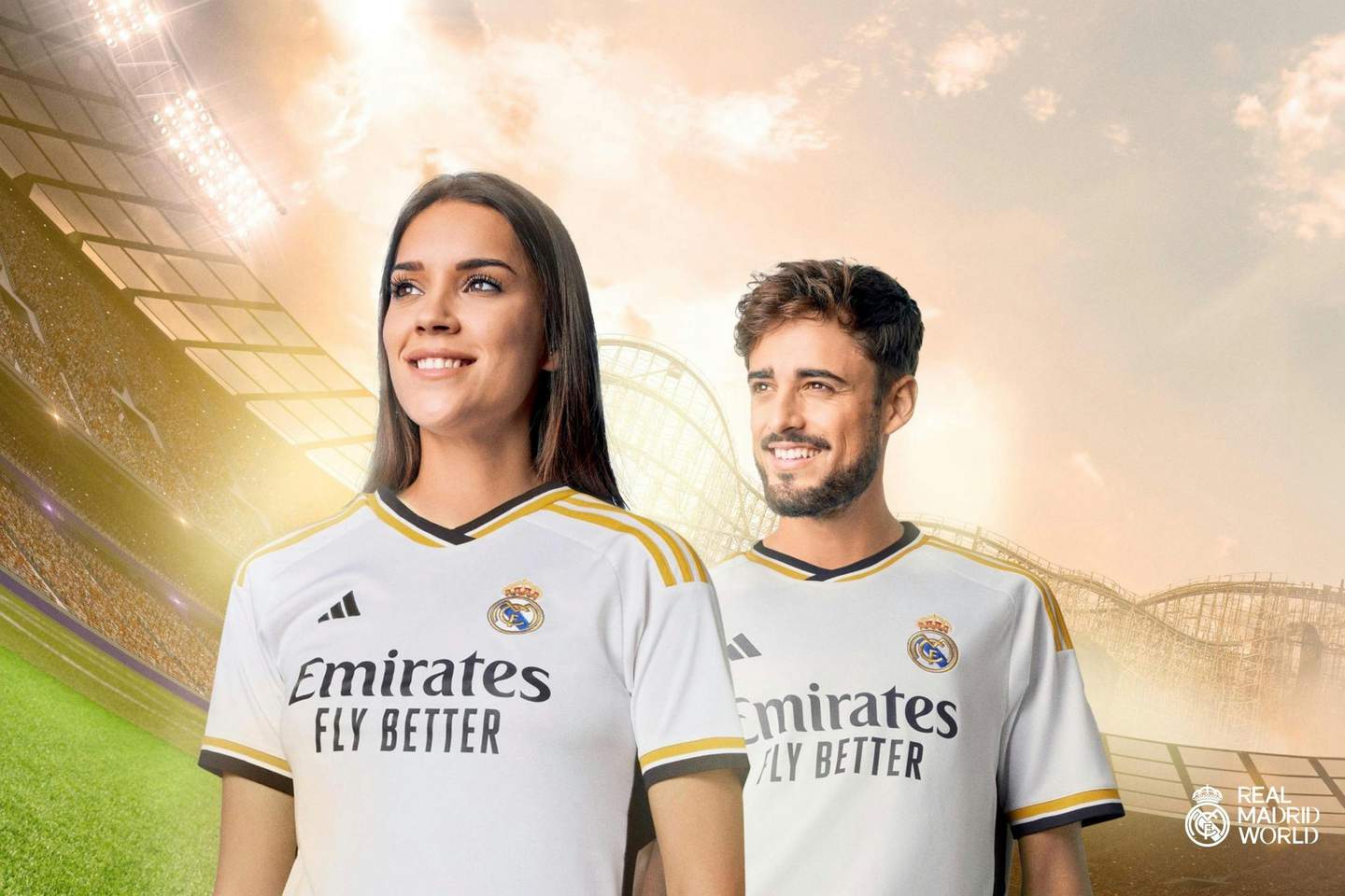 Real Madrid World City Card (Dubai) A woman and a man smiling, wearing Real Madrid jerseys, in a brightly lit stadium with a sunset sky. Real Madrid World logo in the corner.