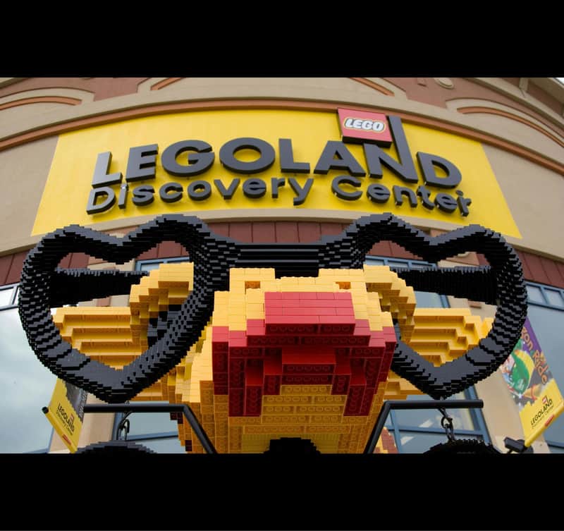 Entrance of LEGOLAND Discovery Center with a large LEGO model featuring a heart-shaped structure in the foreground.