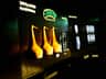 Backlit display showing different stages of whiskey production: distillation, grain whiskey, and maturation with accompanying images.