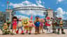 Costumed characters from popular children's shows stand in front of Parque de Atracciones de Madrid entrance.