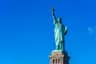 Statue of Liberty City Cards & Passes (New York) The Statue of Liberty, holding a torch and a tablet, stands against a clear blue sky.