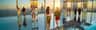 SUMMIT One Vanderbilt City Card (New York) People stand and walk on a mirrored observation deck with a view of a city skyline at sunset.